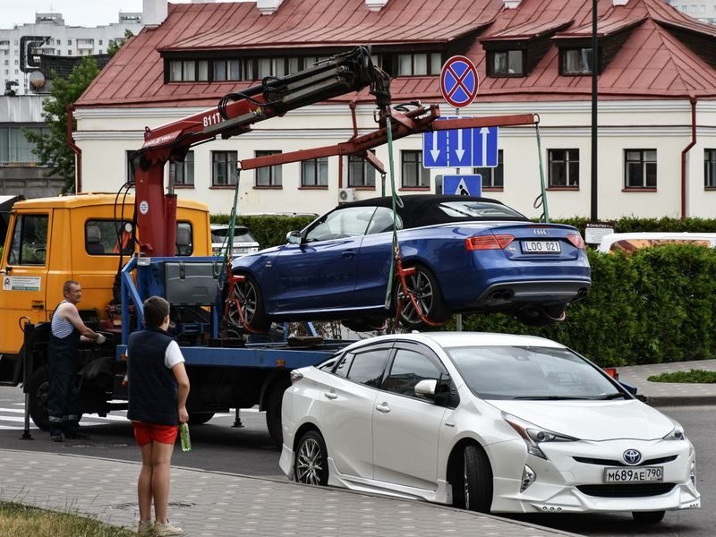 Car loaded onto a tow truck at the roadside