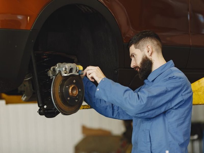 Mechanic replacing the brakes on a car